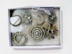 Seven various diamante and other brooches, including crescent-pattern and one with polychrome semi-