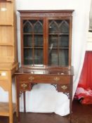 An Edwardian mahogany display cabinet, with blind fretwork frieze, pair of astragal-glazed doors,