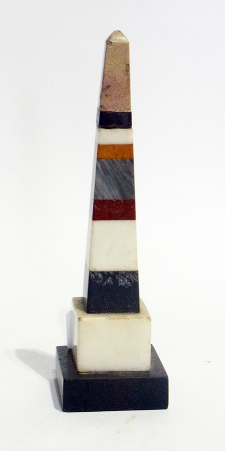 A polished stone obelisk of various different coloured layers, 18cm high