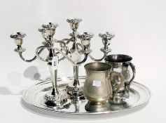 A silver plate oval tray, a pair of three branch candelabrum and a pair of one pint tankards, of
