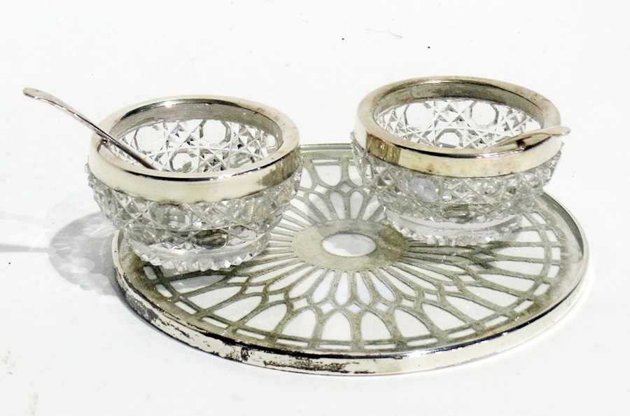 A pair of Edwardian cut glass open salts with silver mounts, together  with spoons, and a silver