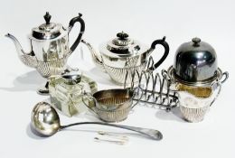 A silver plate ladle, muffin dish and cover, toast rack, matching teapot, coffee pot, cream jug