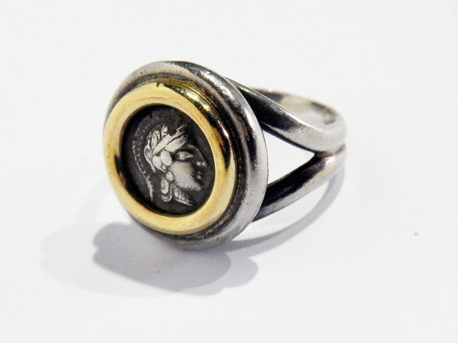 White and yellow metal coin set ring with portrait medallion of centurion, stamped 750 and 950