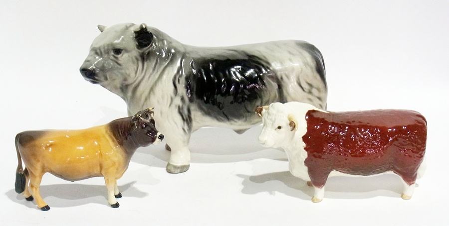 A Beswick bull and cow and another model of a bull (3)