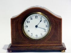 Edwardian oak clock, dome shaped, satinwood stringing on stepped foot and four round brass pad feet,