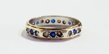 A gold-coloured blue and white stone full eternity ring