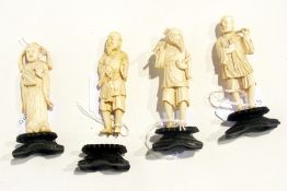 Four Japanese carved ivory figures on carved ebony bases, circa Meiji period, depicting farmer,