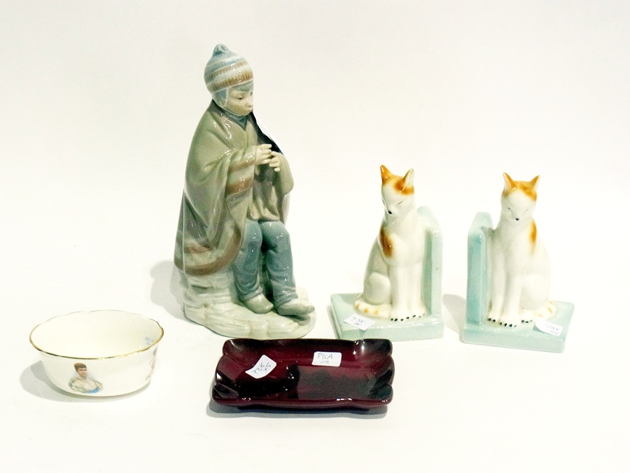 A Nao figure of boy seated with rug, two catkins, commemorative trinket bowl and a red dish (5)