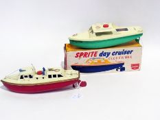 A Sutcliffe tinplate clockwork toy, Sprite Day Cruiser (boxed) together with a Sutcliffe pilot