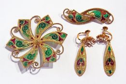 Silver gilt applique azure brooch in green and red, swirl and scroll pattern, another similar design