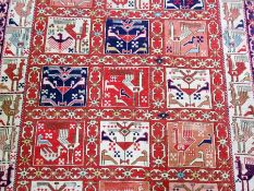 Soumak carpet, red ground with cream and blue border and square medallions, decorated with ostriches