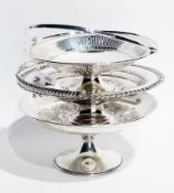Two silver plate raised fruit bowls, with hinged swing handles, together with another fruit bowl