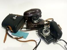 A pair of Ashai Pentax binoculars (cased), Zeiss Ikon camera and a Canon camera