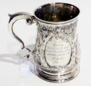 A George II silver baluster-shaped mug with foliate scrolled handle, with later repousse pattern