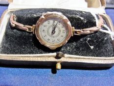 A lady's 9ct gold cased wristwatch, with jewelled Swiss movement, on an extending link strap