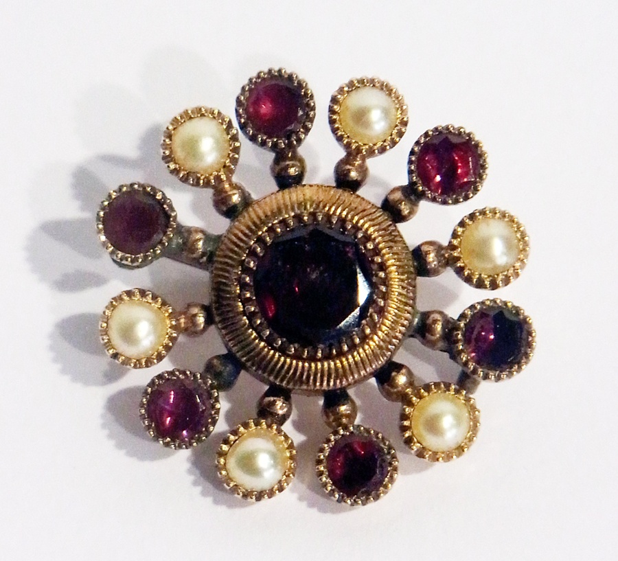 A Victorian gold, almandine garnet and seedpearl circular brooch, inscribed to the reverse "Eliz