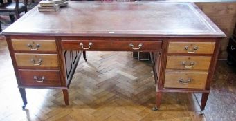 An Edwardian mahogany partner's desk with brown leather inset top and an arrangement of seven