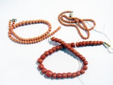 Two strings of pale-colour small graduated coral beads, one with gold-coloured clasp and quantity