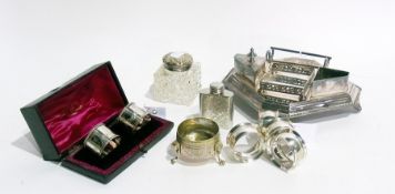 A pair of silver plated napkin rings, boxed, four further napkin rings, open salt, ink stand,