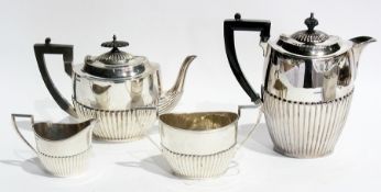 An Edwardian silver three piece tea service, half fluted Georgian style, comprising teapot, sugar