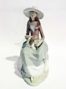 Lladro figure of a lady seated with a dog, 33cm high