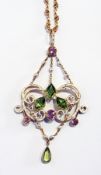 An Edwardian enamel peridot and pink tourmaline Giuliano-style pendant, having three trapezoid-
