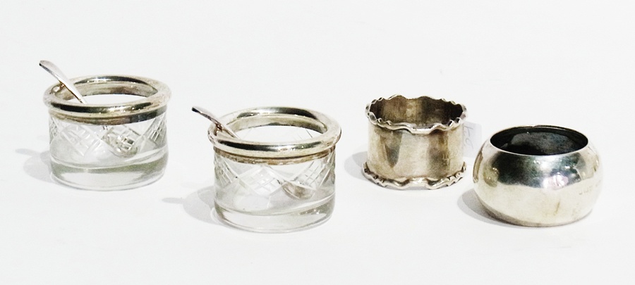 An early 20th century silver napkin ring, of plain form, inscribed "John", Birmingham 1908, another,