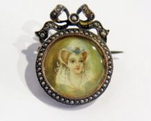 A silver-coloured metal French-style circular portrait brooch with fine seedpearl border and