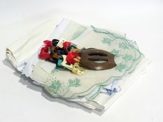 A quantity of coloured plastic and wood buckles, a quantity of embroidered and crocheted table