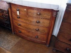 A Victorian mahogany bow-fronted chest of two short and three long drawers, with turned handles,