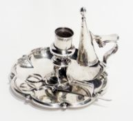A George IV silver chamberstick, the petal-shaped pan with scroll handle together with a conical