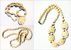 A string of turned bone beads and two carved bone necklaces