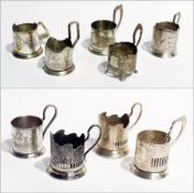 Russian white metal tea glass holders, various designs, some commemorative (9)