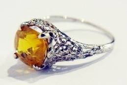 White metal and yellow sapphire dress ring, the cushion-shaped stone 4.5ct approx, in pierced