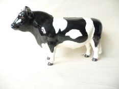 A Beswick black and white Friesian bull inscribed "C H Coddington, Hill Bar" (chip to ear)