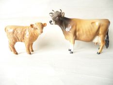 A Beswick Guernsey cow and a Beswick Highland calf