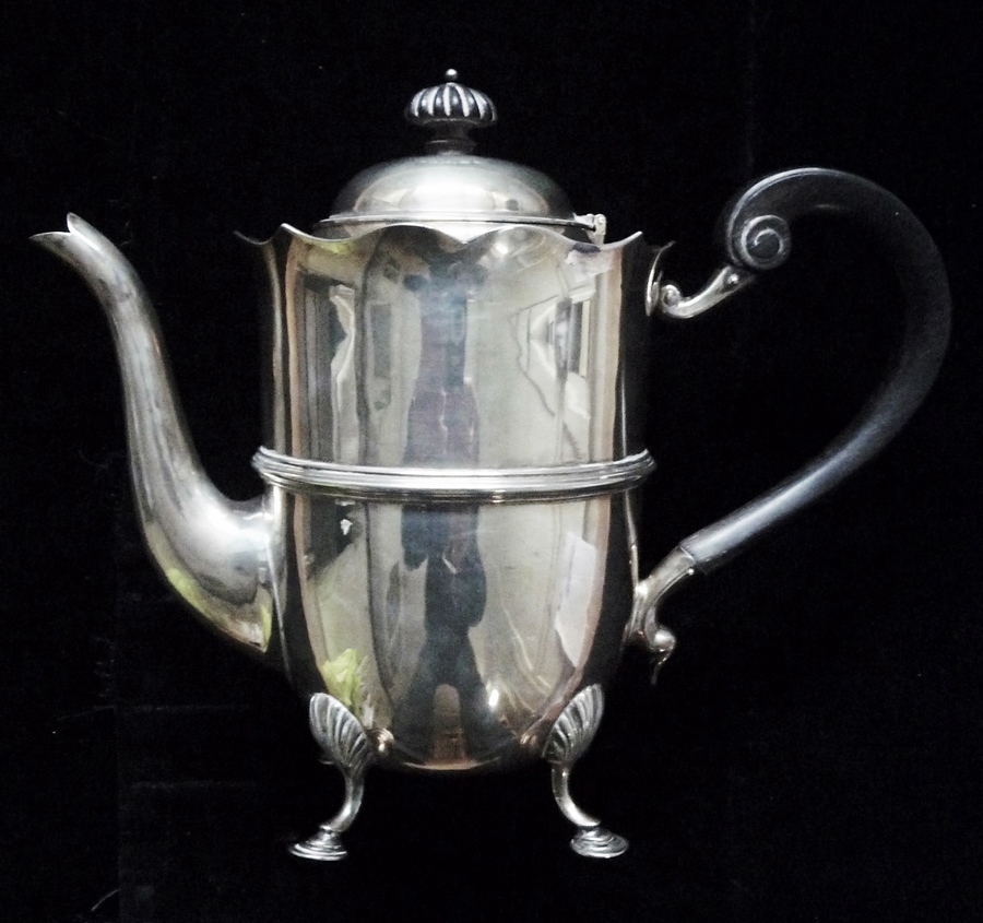 A silver coffeepot by Mappin and Webb standing on four shaped legs with pad feet, London 1902,