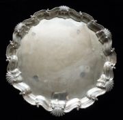 A silver salver having scrolled piecrust rim on three claw and ball feet, 25oz, London 1891