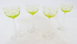 Set of four Art Nouveau green and clear engraved and cut stemmed wines, each with ogee bowl engraved