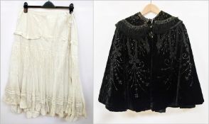 A Victorian black velvet cape, heavily embroidered with faux-jet beads and ribbon detail, fringing