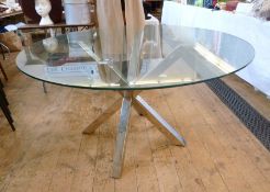 Modern glass and metal dining table, comprising metal supports and circular glass top, height 76cm