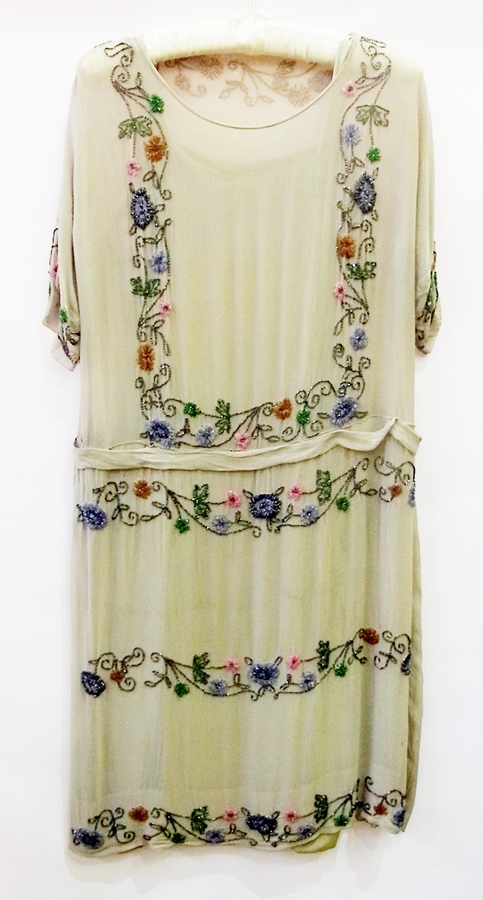 A 1920's sage coloured drop waisted chiffon dress in multi-colour decorations with bugle beads