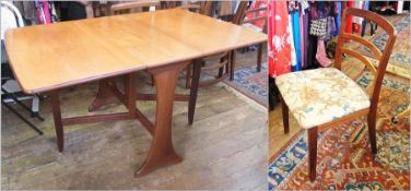 A 1970's G-Plan light wood drop leaf dining table, 91cm across approx and four G-plan dining chairs,