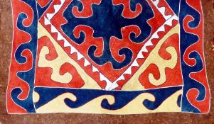 A Turkish felt rug, with yellow, red and blue lozenge medallions with conforming border, 318cm x