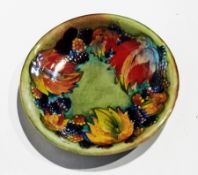 Moorcroft flambe "Leaf and Berry" shallow dish with everted rim, slip-trailed and painted decoration