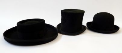 A black bowler hat, size seven, a black top hat, Golden Anchor Company Gloucester and another