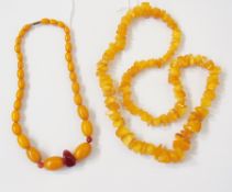 A honey-coloured amber necklace and another amber and cornelian necklace (2)