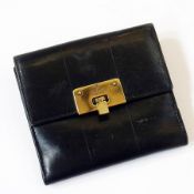 Gucci black leather wallet, with metal clasp, engraved "Gucci, made in Italy"