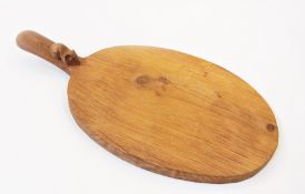 A Mouseman carved wood cheese board, oval with mouse to handle