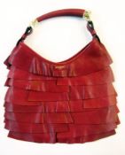 Yves St Laurent wine coloured leather handbag, with paneled layers, tapering gilt mounted handle,